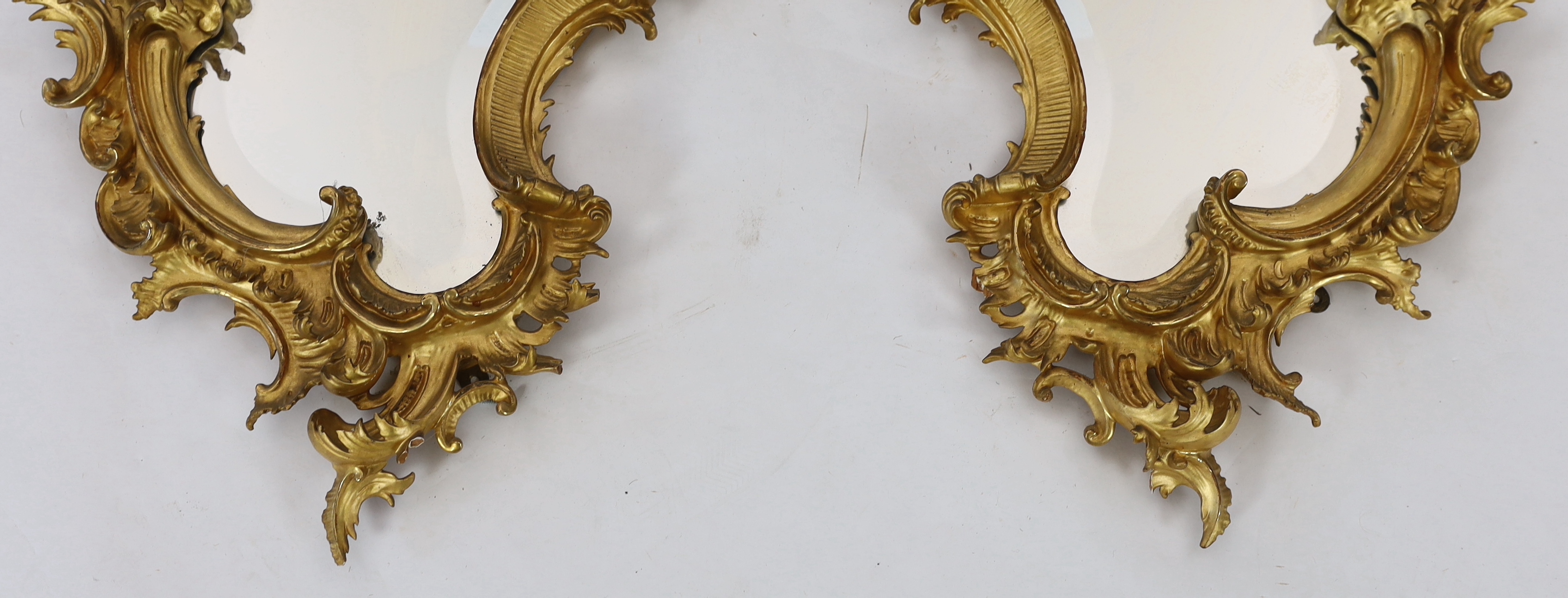 A pair of 19th century carved giltwood wall mirrors in the Rococo style, width 57cm, height 96cm